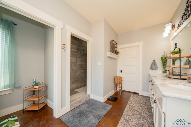 bathroom featuring vanity, concrete flooring, and walk in shower