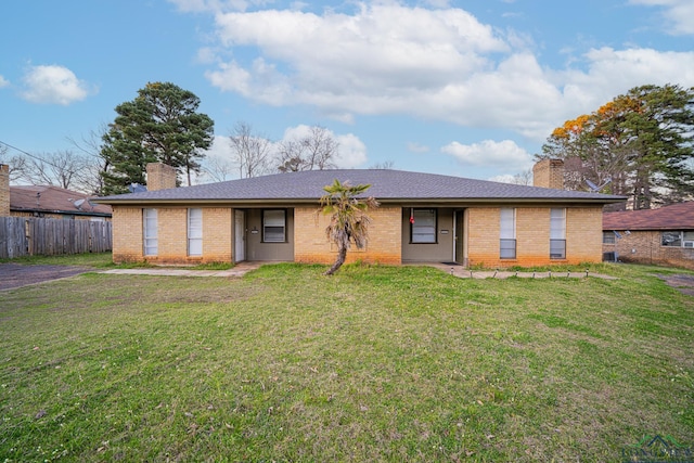 single story home featuring a chimney, fence, and a front yard