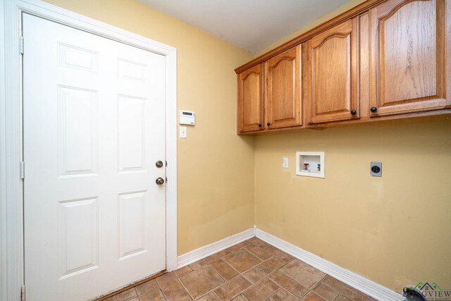 washroom with washer hookup, cabinet space, electric dryer hookup, and baseboards