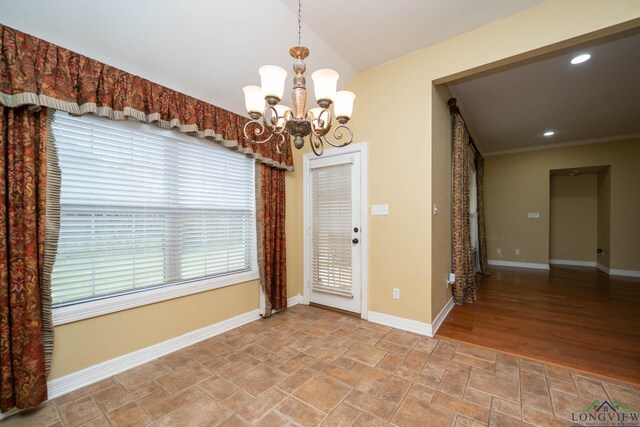 interior space featuring a chandelier, recessed lighting, stone finish flooring, and baseboards