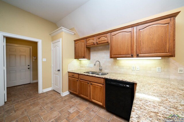 kitchen featuring light stone countertops, black dishwasher, decorative backsplash, and a sink