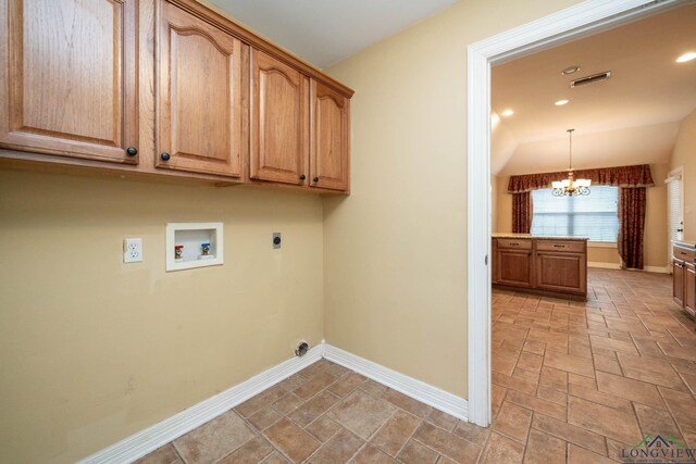 laundry area with hookup for a washing machine, cabinet space, visible vents, hookup for an electric dryer, and a chandelier