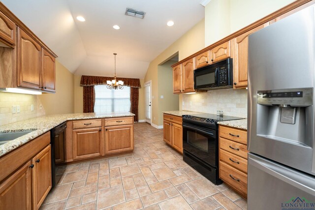 kitchen featuring visible vents, an inviting chandelier, vaulted ceiling, a peninsula, and black appliances