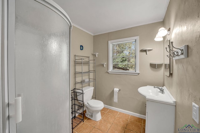 bathroom with ornamental molding, vanity, a shower with door, tile patterned flooring, and toilet