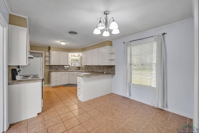 kitchen featuring decorative backsplash, a notable chandelier, white cabinets, white electric range, and hanging light fixtures