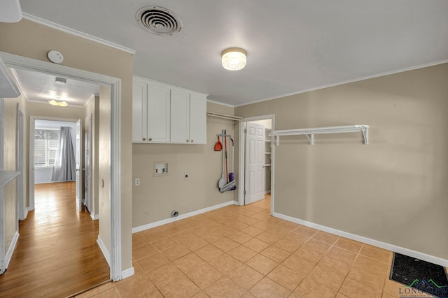 laundry room featuring cabinets, hookup for a gas dryer, crown molding, hookup for a washing machine, and hookup for an electric dryer