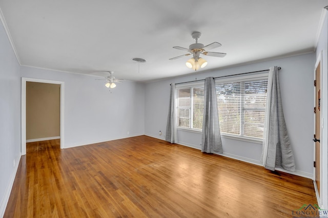 spare room with wood-type flooring and crown molding