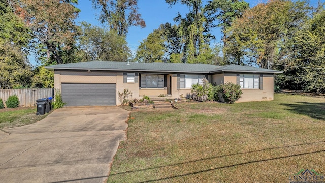 ranch-style home featuring a front lawn and a garage