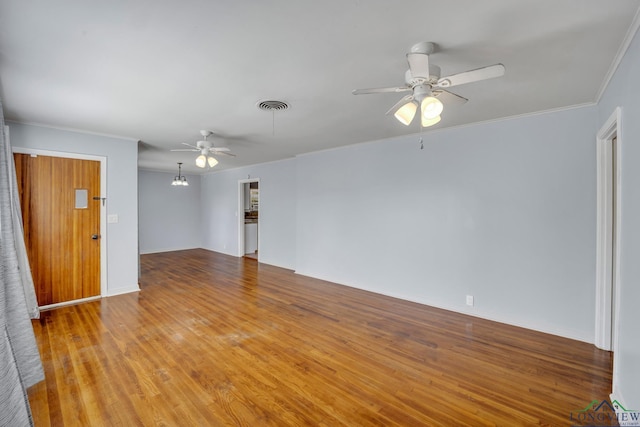 spare room featuring ceiling fan, crown molding, and light wood-type flooring