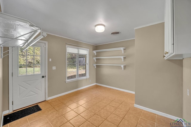 interior space featuring crown molding and light tile patterned flooring