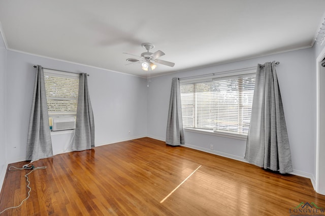 empty room featuring ceiling fan, hardwood / wood-style floors, and crown molding