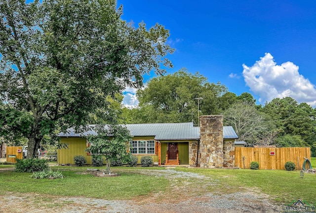 8227 N Kings Hwy, Texarkana, TX 75503 - view of front facade with a metal roof, a chimney, and stone siding