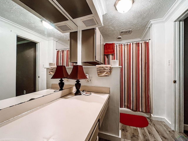 8227 N Kings Hwy, Texarkana, TX 75503 - bathroom featuring a textured ceiling, wood finished floors, ornamental molding, vanity, and a shower with curtain