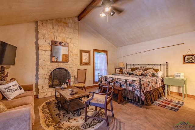 bedroom featuring ceiling fan, a fireplace, and lofted ceiling with beams