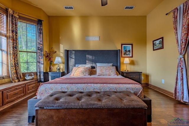 bedroom with ceiling fan and dark wood-type flooring