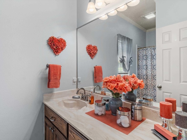 bathroom with crown molding and vanity