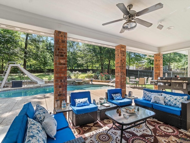 view of patio / terrace featuring a fenced in pool, an outdoor living space, and ceiling fan