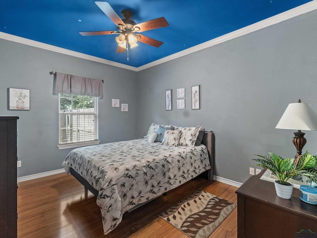 bedroom featuring hardwood / wood-style flooring, ceiling fan, and ornamental molding