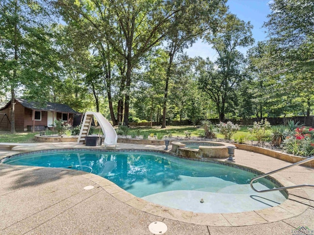 view of pool featuring an in ground hot tub, a patio, and a water slide