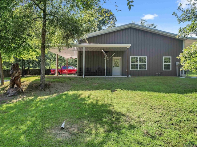 back of property featuring a yard and a carport