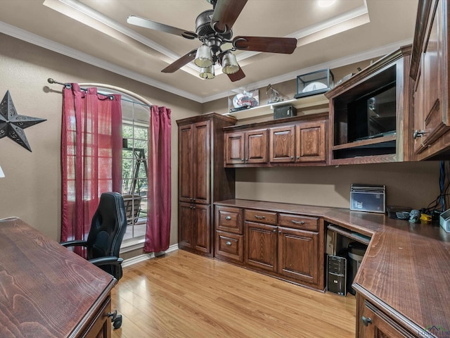 home office featuring a raised ceiling, crown molding, light hardwood / wood-style flooring, and ceiling fan