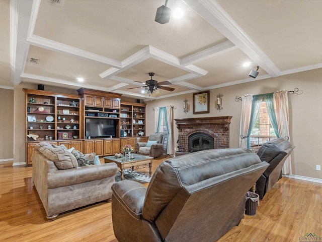 living room with light wood-type flooring, ceiling fan, crown molding, and coffered ceiling