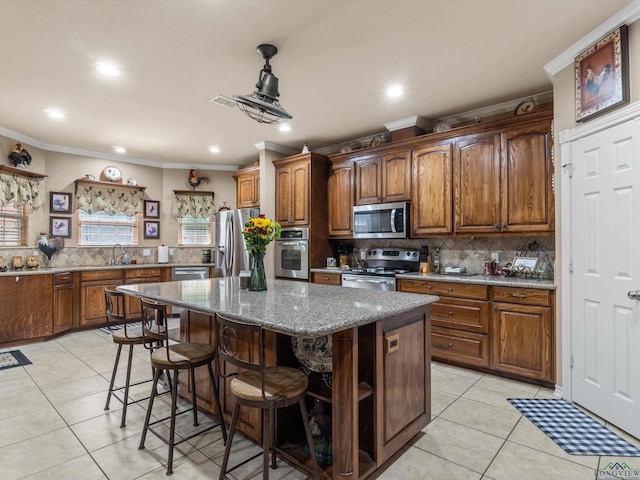 kitchen featuring stainless steel appliances, light tile patterned floors, stone countertops, decorative backsplash, and a kitchen island