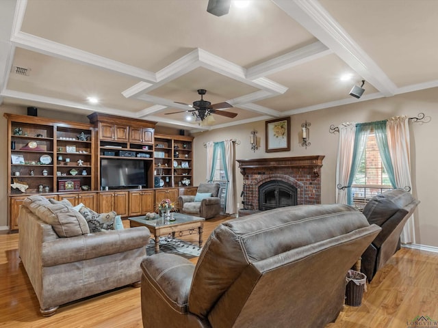 living room with ceiling fan, a fireplace, light hardwood / wood-style floors, and coffered ceiling