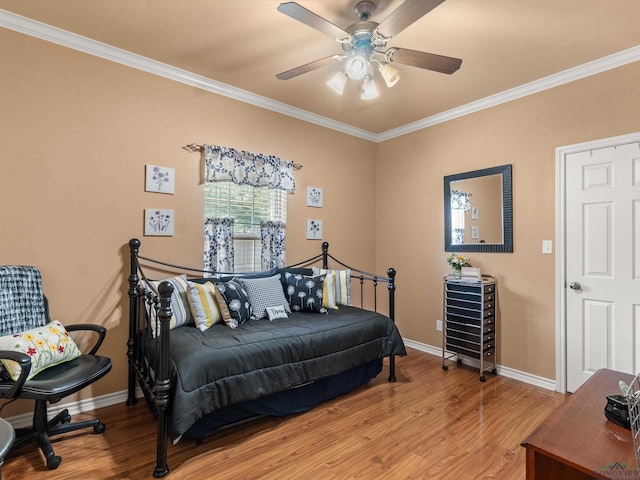 bedroom featuring hardwood / wood-style floors, ceiling fan, and crown molding