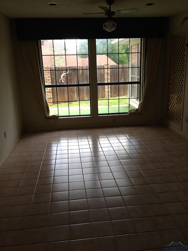 1204 Brandywine Dr, Longview, TX 75601 - tiled spare room featuring ceiling fan and a textured ceiling