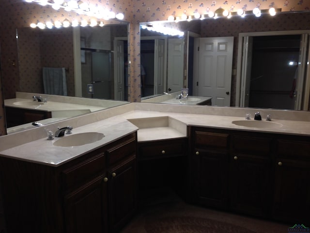 1204 Brandywine Dr, Longview, TX 75601 - bathroom featuring wallpapered walls, double vanity, and a stall shower