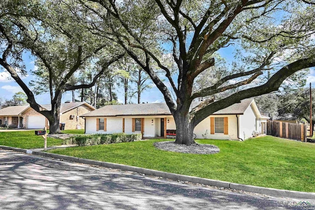 single story home featuring a garage and a front yard