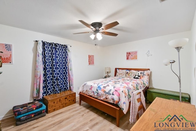 bedroom with hardwood / wood-style flooring and ceiling fan