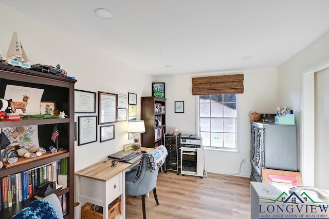 office with light wood-type flooring