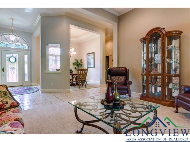 1018 Brown Dr, Texarkana, TX 75501 - tiled living area with a chandelier, ornamental molding, baseboards, and carpet