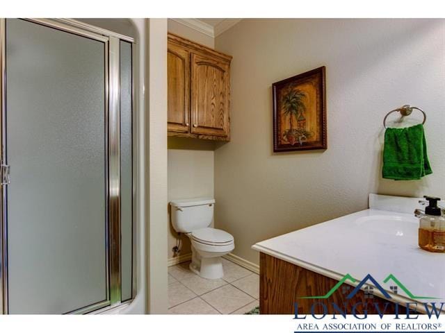 1018 Brown Dr, Texarkana, TX 75501 - bathroom featuring toilet, tile patterned floors, a shower stall, crown molding, and baseboards