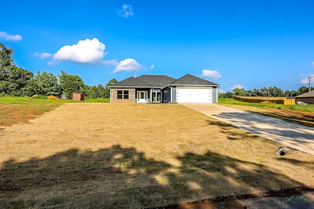 view of front of house with a garage and a front lawn