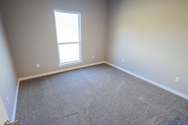 carpeted spare room featuring a healthy amount of sunlight