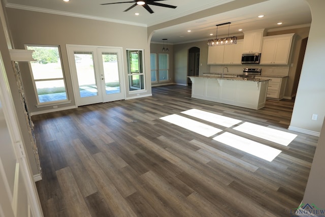 unfurnished living room with french doors, ceiling fan, crown molding, dark wood-type flooring, and sink