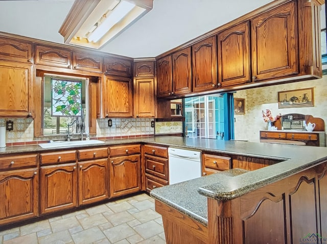 2495 N Fm 312, Winnsboro, TX 75494 - kitchen with dishwasher, dark stone countertops, decorative backsplash, sink, and kitchen peninsula