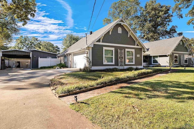 view of front facade with a carport, a front yard, and a garage