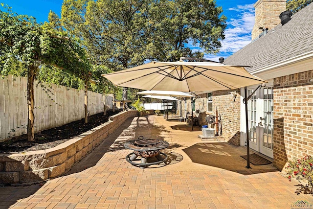 view of patio featuring french doors and an outdoor fire pit