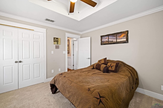 bedroom with carpet flooring, ceiling fan, a closet, and ornamental molding