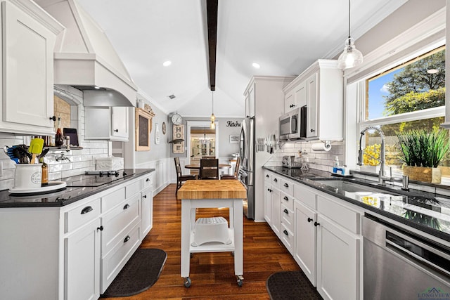 kitchen featuring butcher block counters, sink, white cabinets, and stainless steel appliances