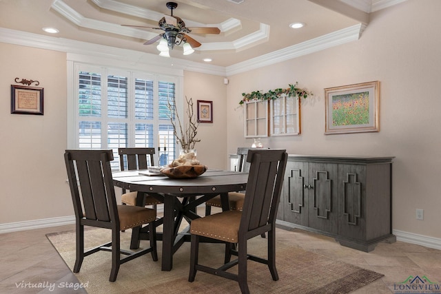 dining space with a tray ceiling, recessed lighting, ornamental molding, a ceiling fan, and baseboards