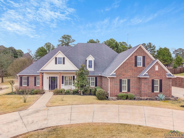 view of front of property with a front yard and brick siding