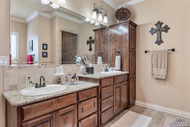 bathroom featuring double vanity, crown molding, backsplash, and a sink