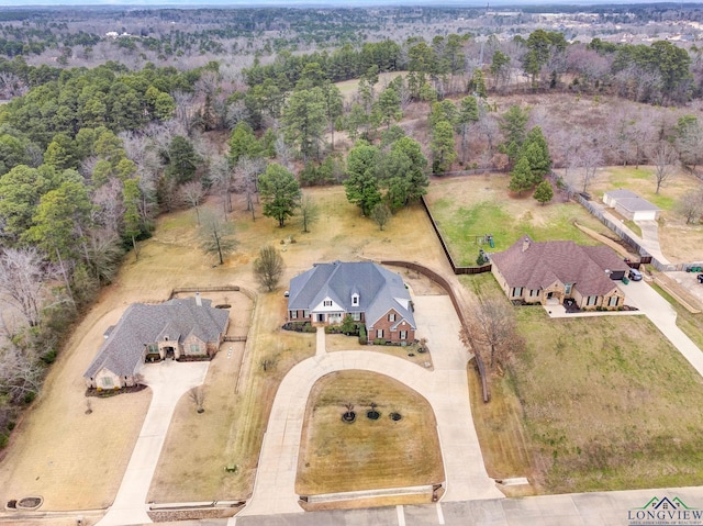 birds eye view of property with a forest view