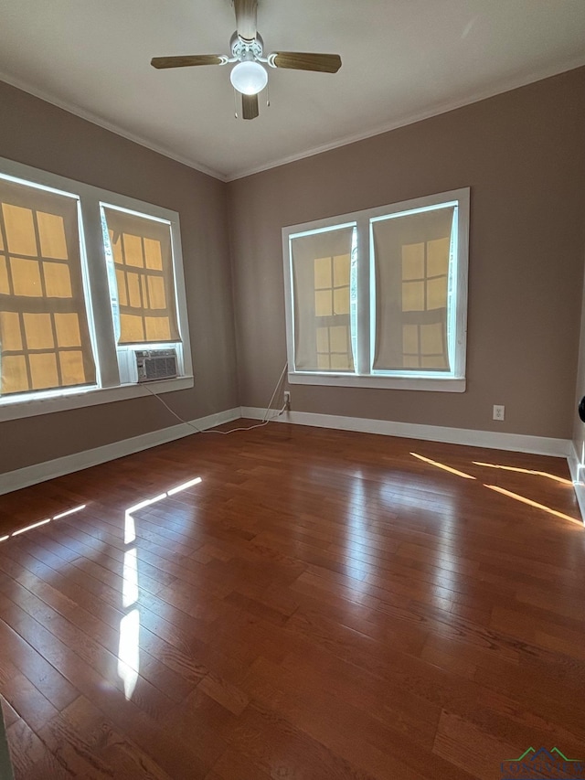 empty room with ceiling fan, crown molding, and dark wood-type flooring