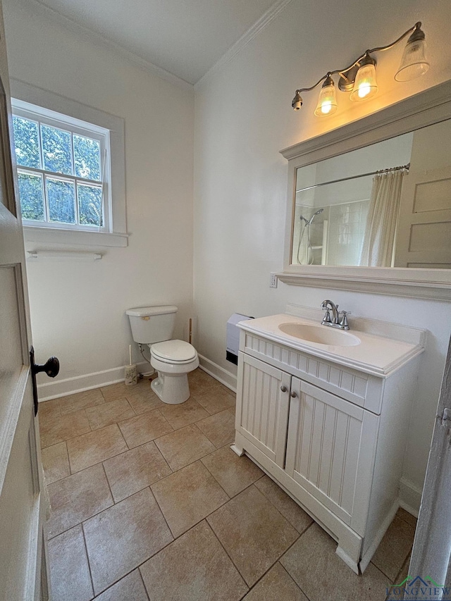 bathroom with vanity, toilet, walk in shower, and ornamental molding